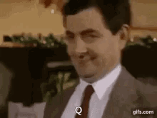 Man In Suit Smiling And Making A Face GIF