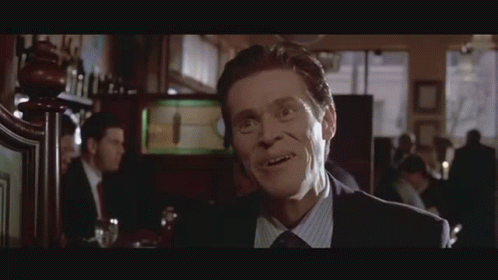 Man in Suit Smiling at Bar