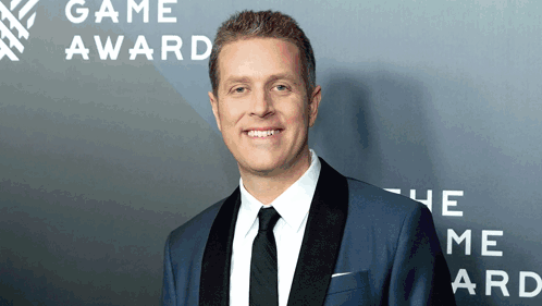Man in Suit Smiling at Game Award