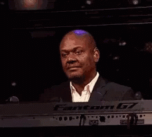Man in Suit Smiling at Keyboard