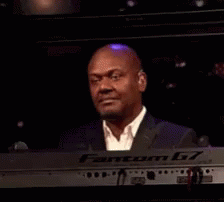 Man in Suit Smiling at Keyboard
