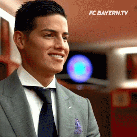 Man In Suit Smiling FC Bayern.tv Logo GIF