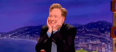 Man in Suit Smiling Hands on Face
