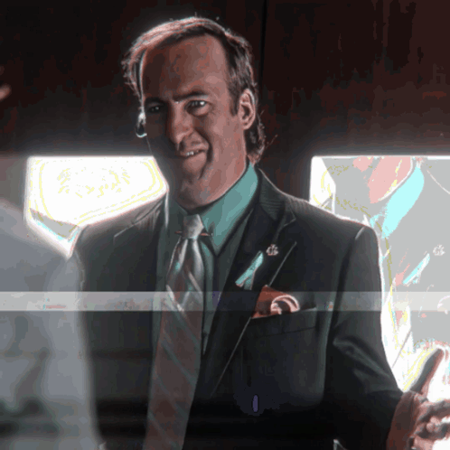 Man in Suit Smiling Holding Phone