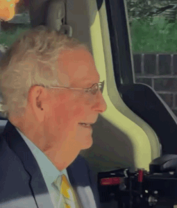 Man in Suit Smiling in Car