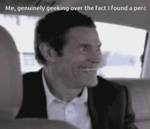 Man in Suit Smiling in Car