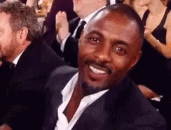 Man in Suit Smiling in Crowd
