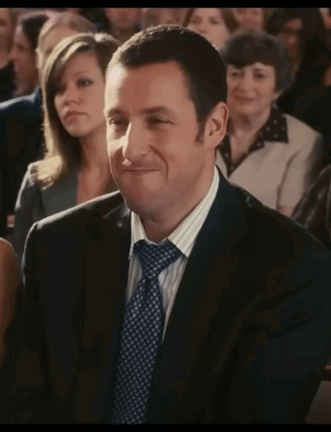 Man in Suit Smiling in Crowd