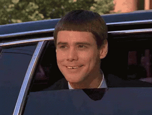 Man In Suit Smiling Out Car Window GIF