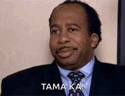 Man in Suit Smiling Says Tama Ka