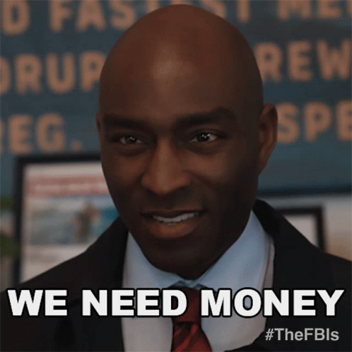 Man in Suit Smiling Says We Need Money