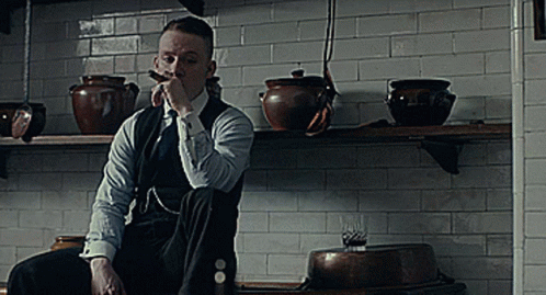 Man In Suit Smoking Cigar In Kitchen GIF