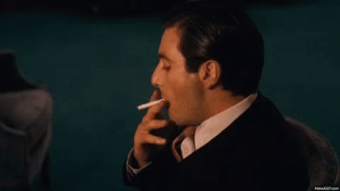 Man In Suit Smoking Cigarette GIF