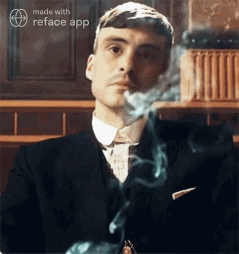 Man In Suit Smoking Cigarette GIF