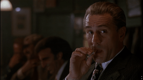 Man in Suit Smoking Cigarette