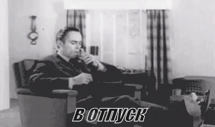 Man in Suit Smoking Cigarette in Living Room