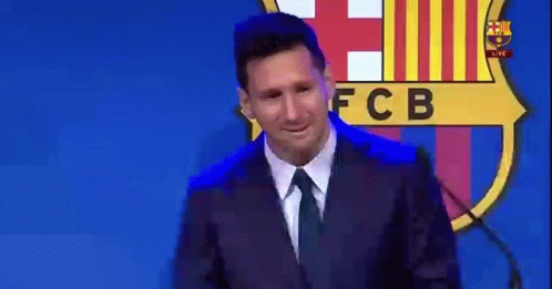 Man in Suit Speaking at Microphone with FCB Logo