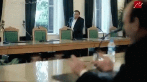 Man In Suit Speaking Into Microphone GIF