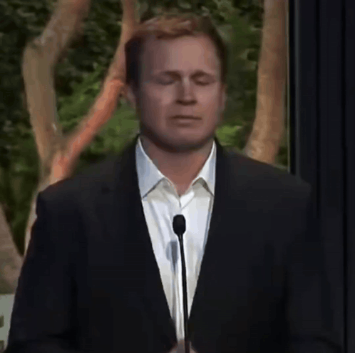 Man In Suit Speaking Into Microphone Eyes Closed GIF