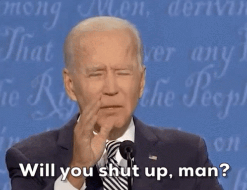 Man in Suit Speaking Into Microphone Says Will You Shut Up Man