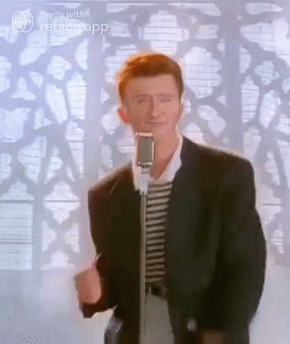 Man In Suit Standing At Microphone GIF