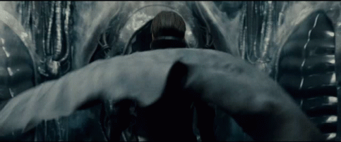 Man In Suit Standing Before Large Object GIF