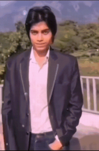 Man In Suit Standing Before Railing GIF