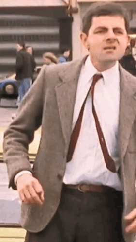 Man In Suit Standing Before Yellow Car GIF