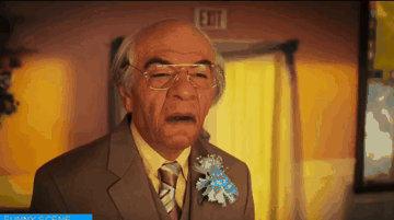 Man in Suit Standing by Exit Sign