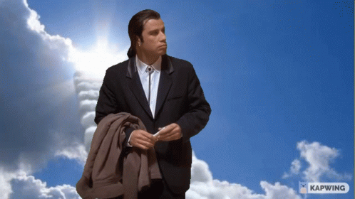 Man In Suit Standing In Blue Sky With Clouds And Kapwing GIF