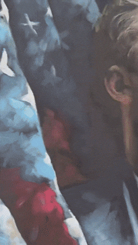 Man in Suit Standing in Front of American Flag