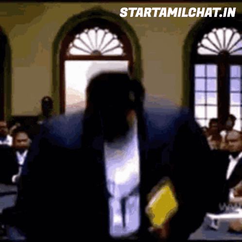 Man In Suit Standing In Front Of Crowd GIF