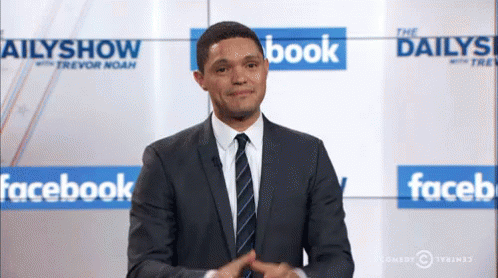 Man In Suit Standing In Front Of Facebook Wall GIF