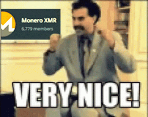 Man in Suit Standing in Front of Monero XMR Sign