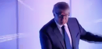 Man in Suit Standing in Front of Projection Screen