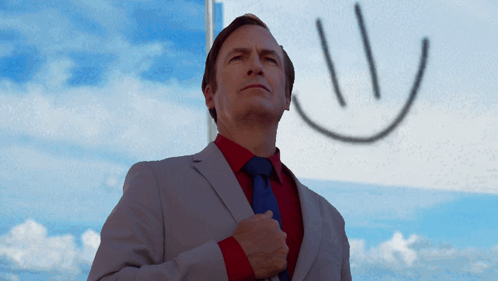 Man in Suit Standing in Front of Smiley Flag