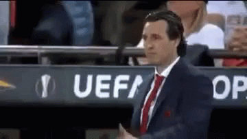 Man in Suit Standing in Front of UEFA Sign