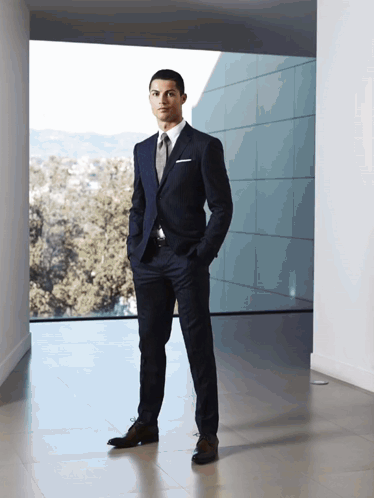 Man in Suit Standing in Front of Window