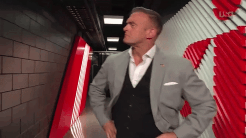 Man in Suit Standing in Hallway