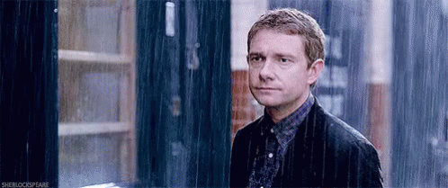 Man in Suit Standing in Rain Looking at Camera