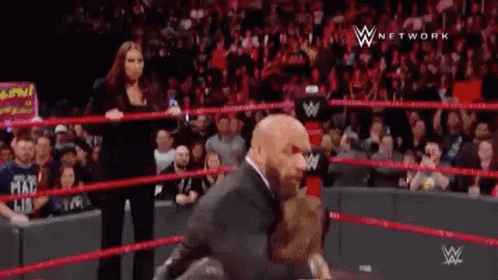Man in Suit Standing in Wrestling Ring