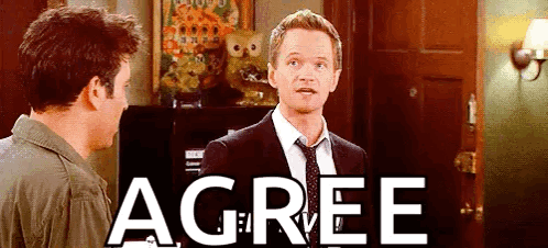 Man In Suit Standing Next To Another Man With Agree On Wall GIF