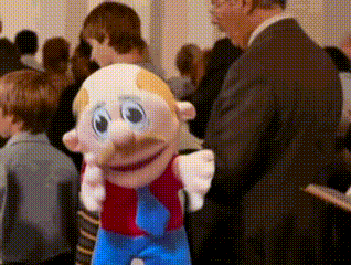 Man in Suit Standing Next to Mustache Toy