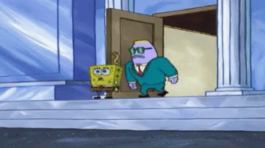 Man in Suit Standing Next to Spongebob