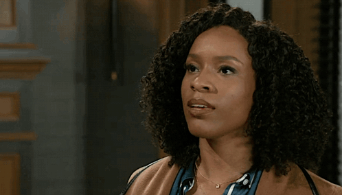 Man In Suit Standing Next To Woman In Brown Coat GIF