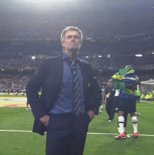Man in Suit Standing on Soccer Field