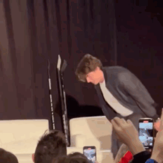 Man In Suit Standing On Stage GIF