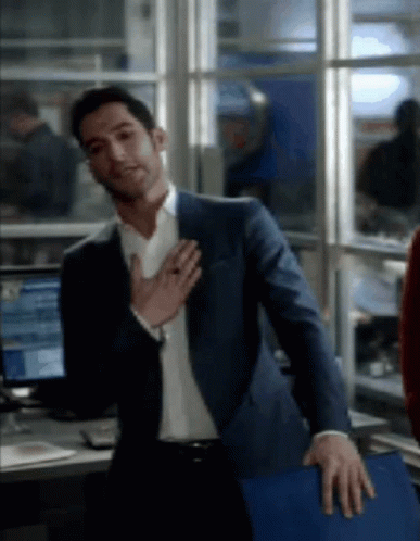 Man In Suit Standing With Hands On Chest GIF