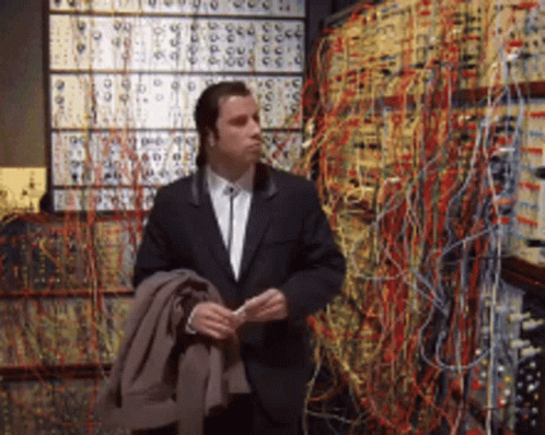 Man in Suit Standing With Numbered Wires