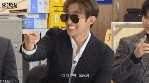 Man in Suit, Sunglasses, and Stack of Milk Boxes